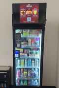 JL Smart Vending machine displaying full restaurant menu with pricing on digital screen